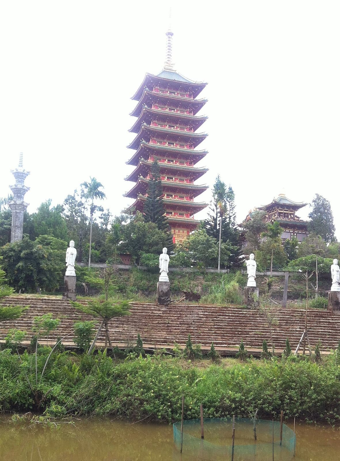 Bảo tháp nhiều tầng và hàng tượng trắng trong khuôn viên chùa Minh Thành, Pleiku